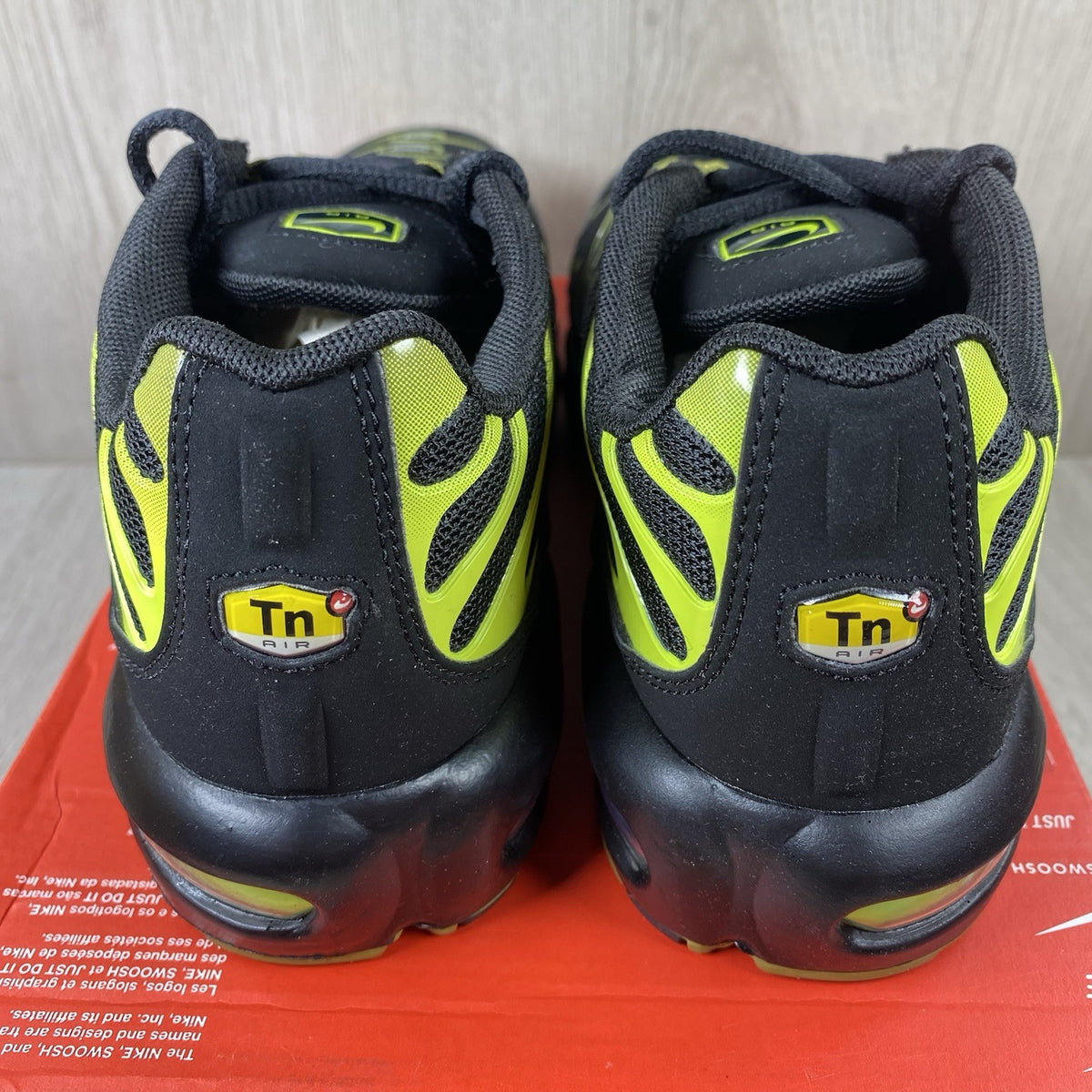 Nike Air Max Plus TN trainers black with cyber accents and mesh upper detailing.