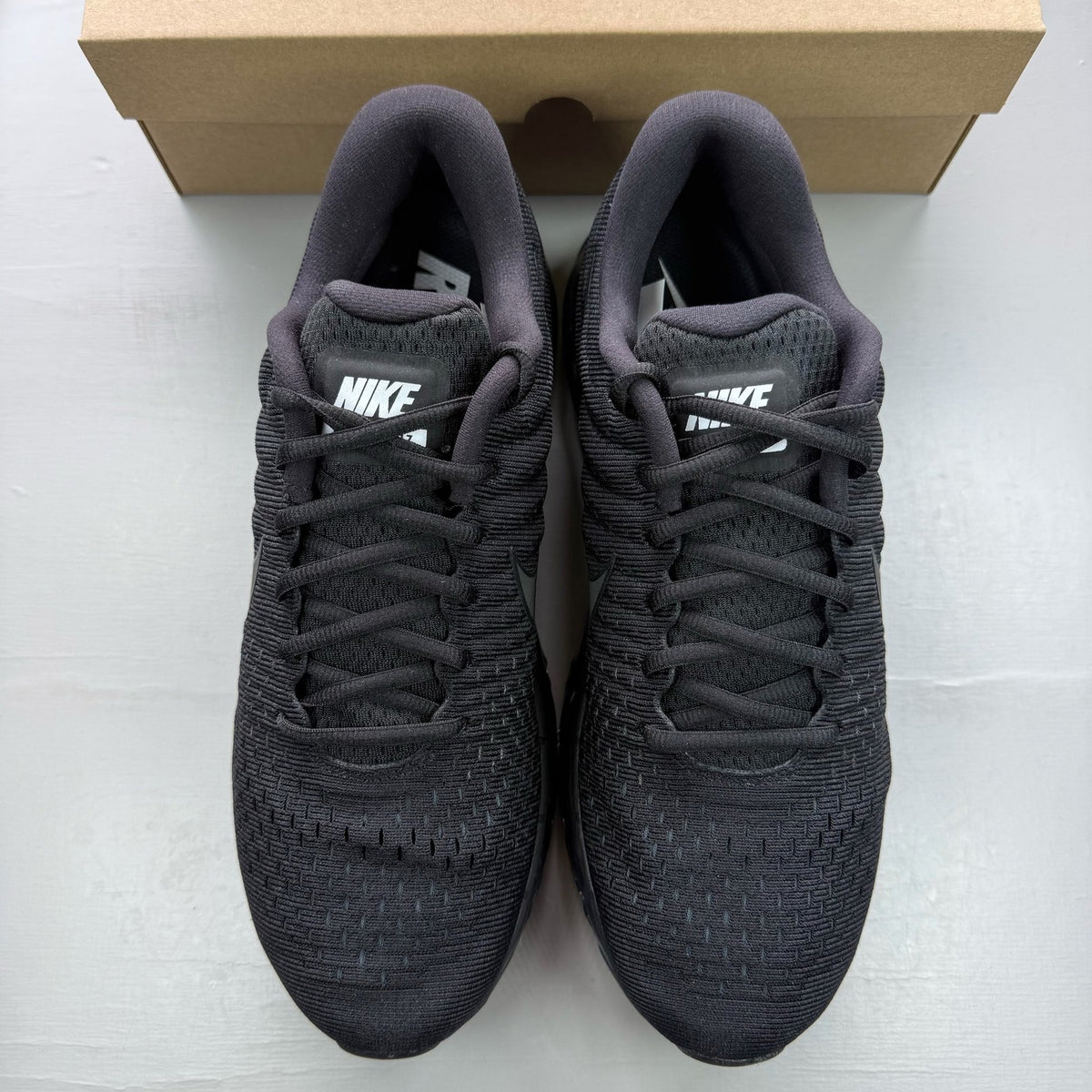 Nike Air Max 2017 black trainers with sleek design and logo detailing.