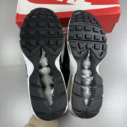 Nike Air Max 95 Essential black trainers with white accents and signature logo details.