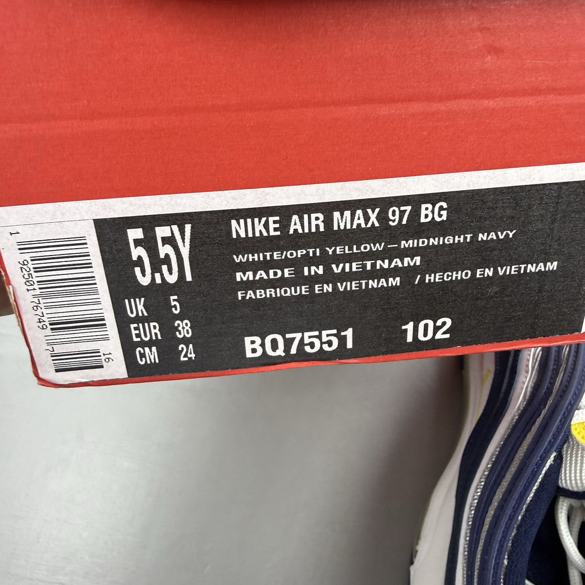 Nike Air Max 97 dark blue trainers with opti yellow and white accents, logo detail.