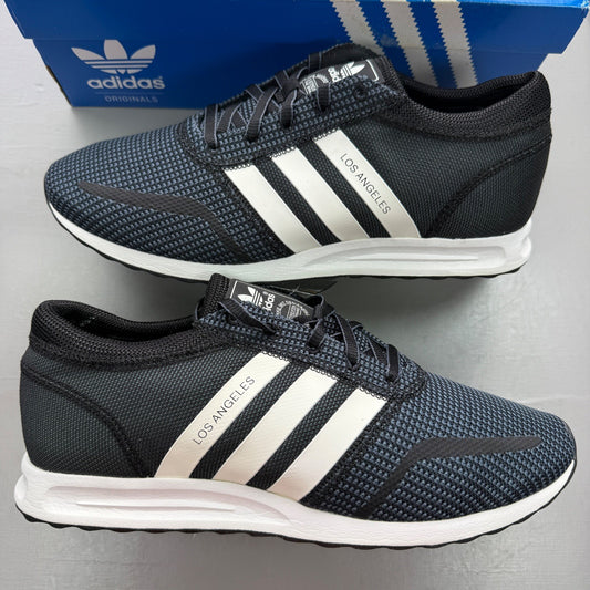 Adidas black deck shoes with white stripes and logo, brand new in box.