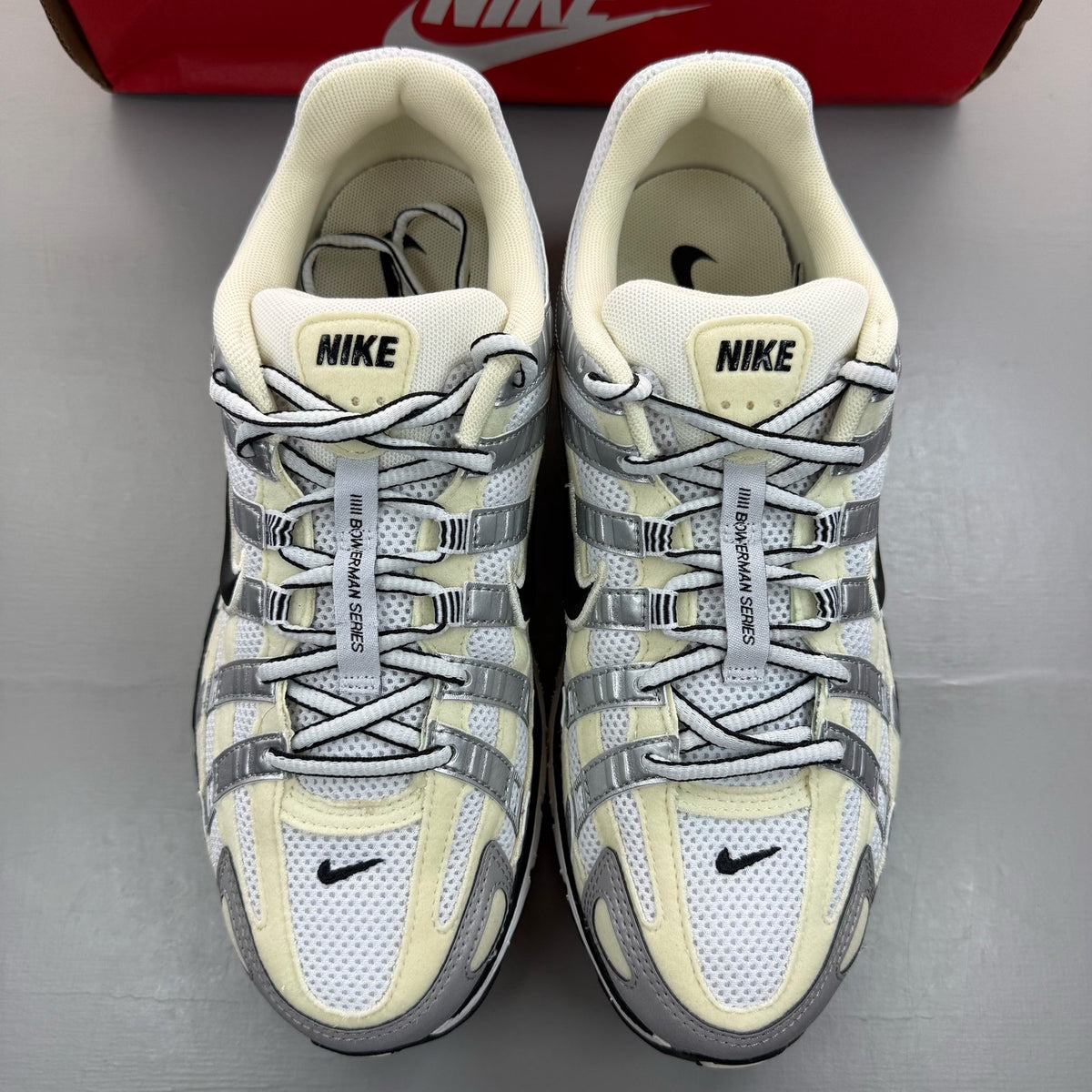 Nike P-6000 white trainers metallic silver accents and mesh detailing.