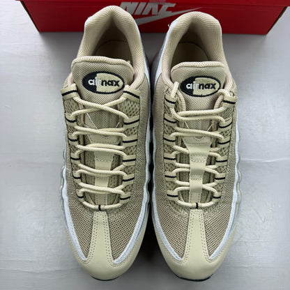Nike Air Max 95 beige trainers with desert khaki accents and logo detailing.