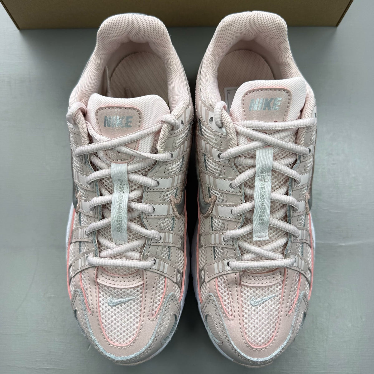 Nike P-6000 pink trainers with mesh upper and logo detailing.