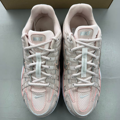 Nike P-6000 pink trainers with mesh upper and logo detailing.