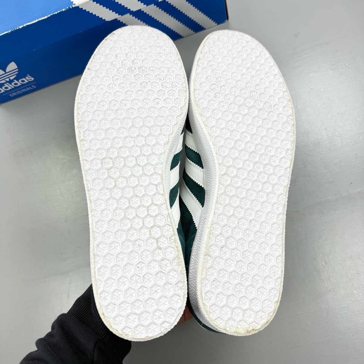 Adidas green suede Gazelle trainers with white stripes and logo detail.