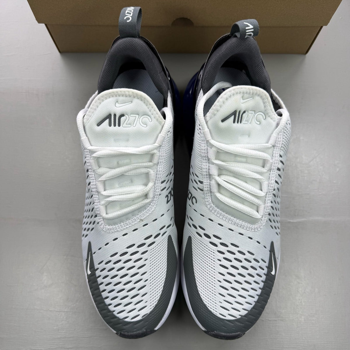 Nike Air Max 270 white trainers with Persian Violet accents and logo detail.