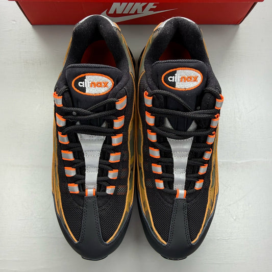 Nike Air Max 95 black trainers with orange camo accents and logo details.