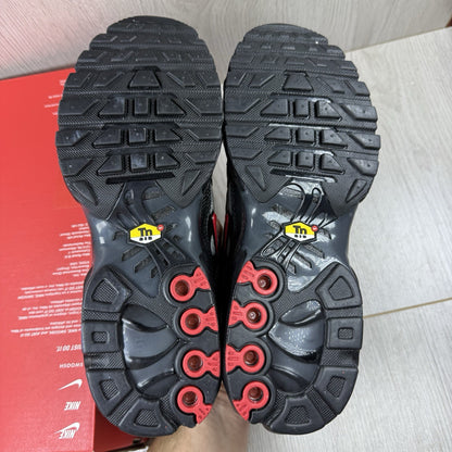 Nike TN Air Max Plus trainers black with red gradient and signature logo design.