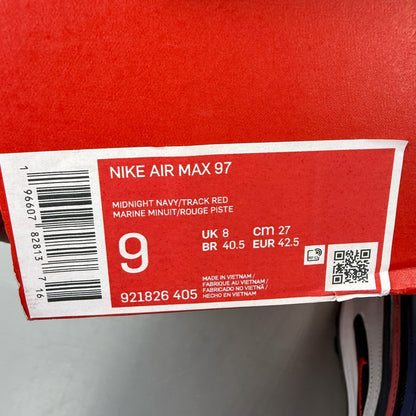 Nike Air Max 97 blue trainers with red accents and iconic logo detailing.