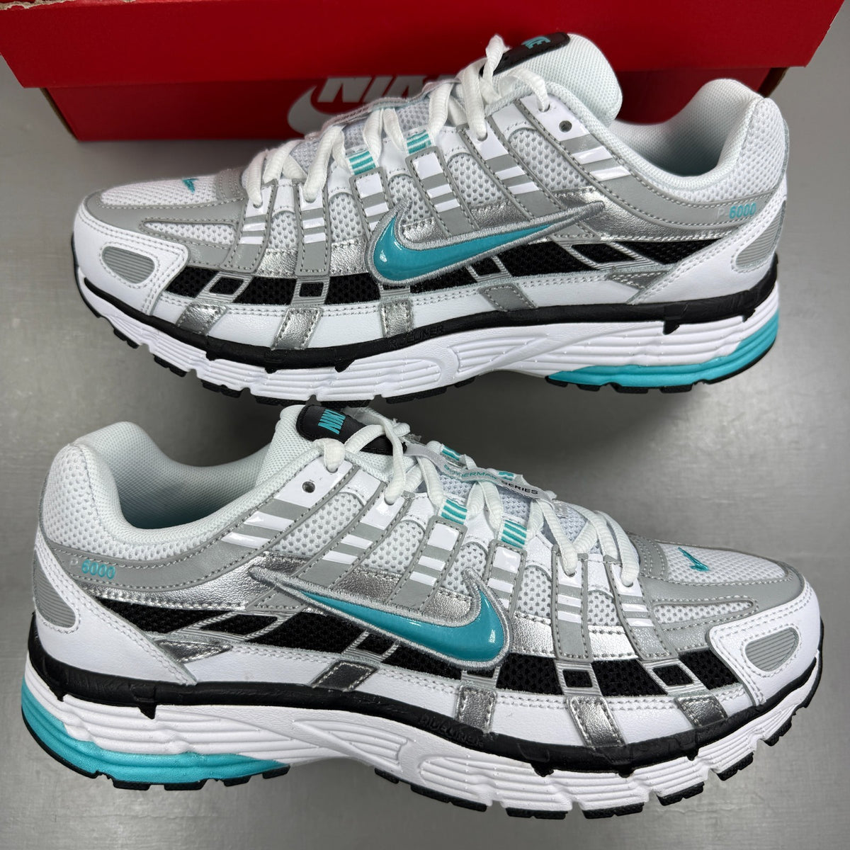 Nike white athletic shoes with dusty cactus accents and mesh upper details.