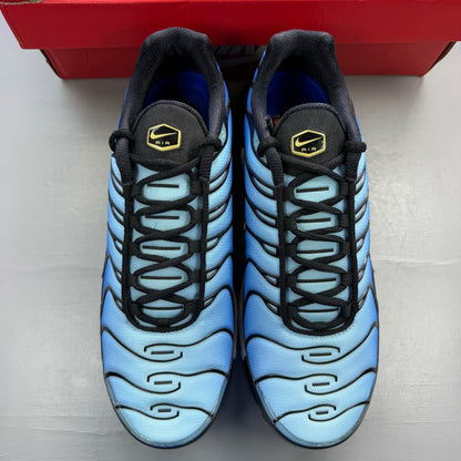 Nike Air Max Plus TN blue trainers with black accents and signature swoosh logo.