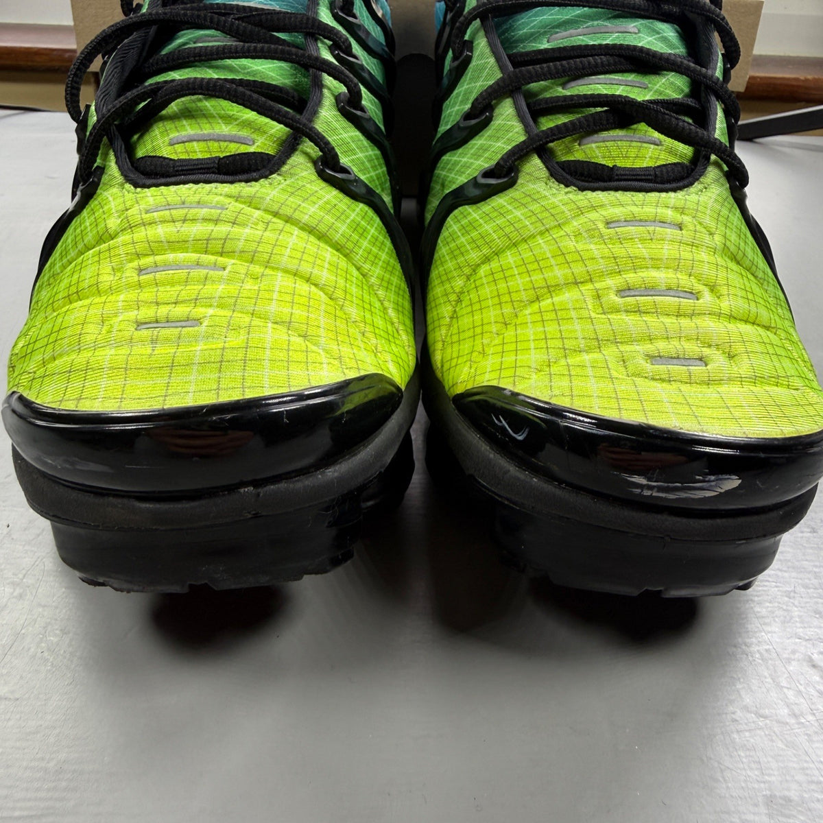 Nike athletic shoes Aurora Green with black accents and signature logo details.