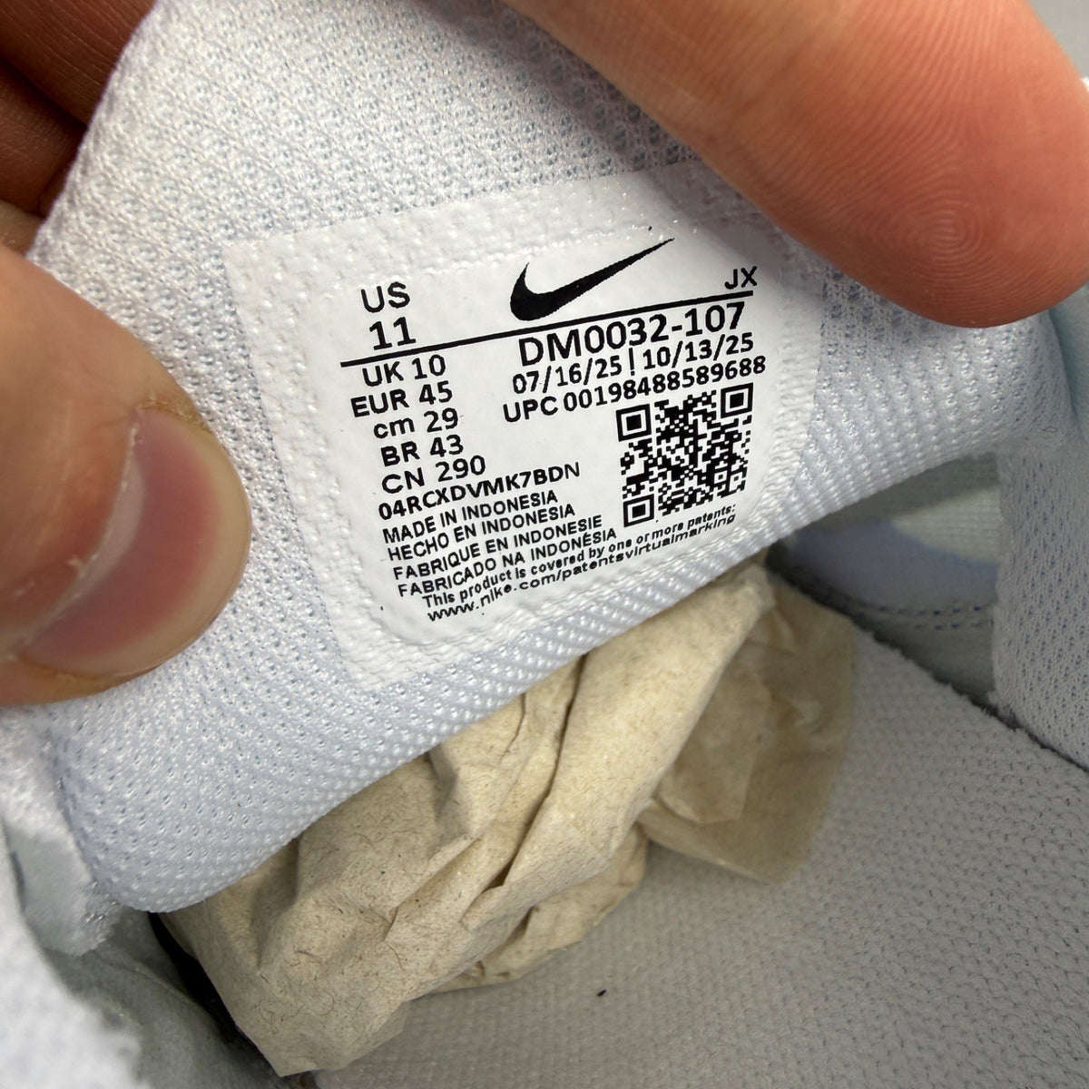 Nike running shoes white with blue accents and signature swoosh logo.