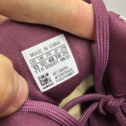Adidas UltraBoost 1.0 DNA red trainers with signature three stripes and knit upper.