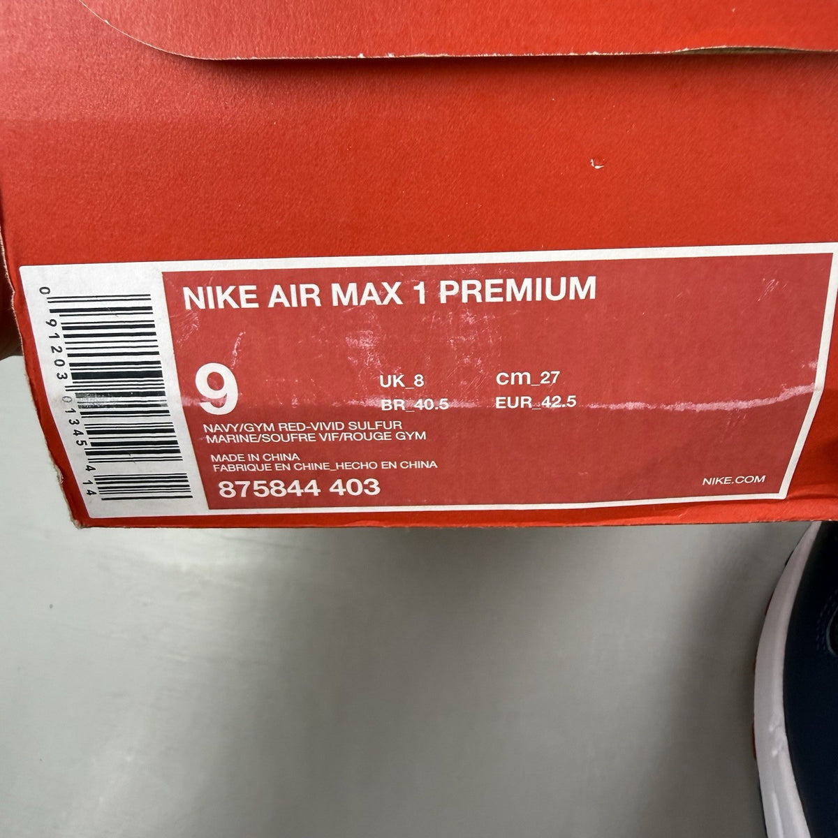 Nike Air Max 1 trainers blue with red and yellow accents, featuring iconic logo and design.