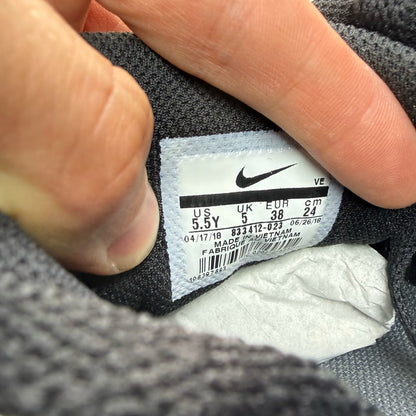 Nike Air Max 90 black trainers with volt accents and signature logo detailing.