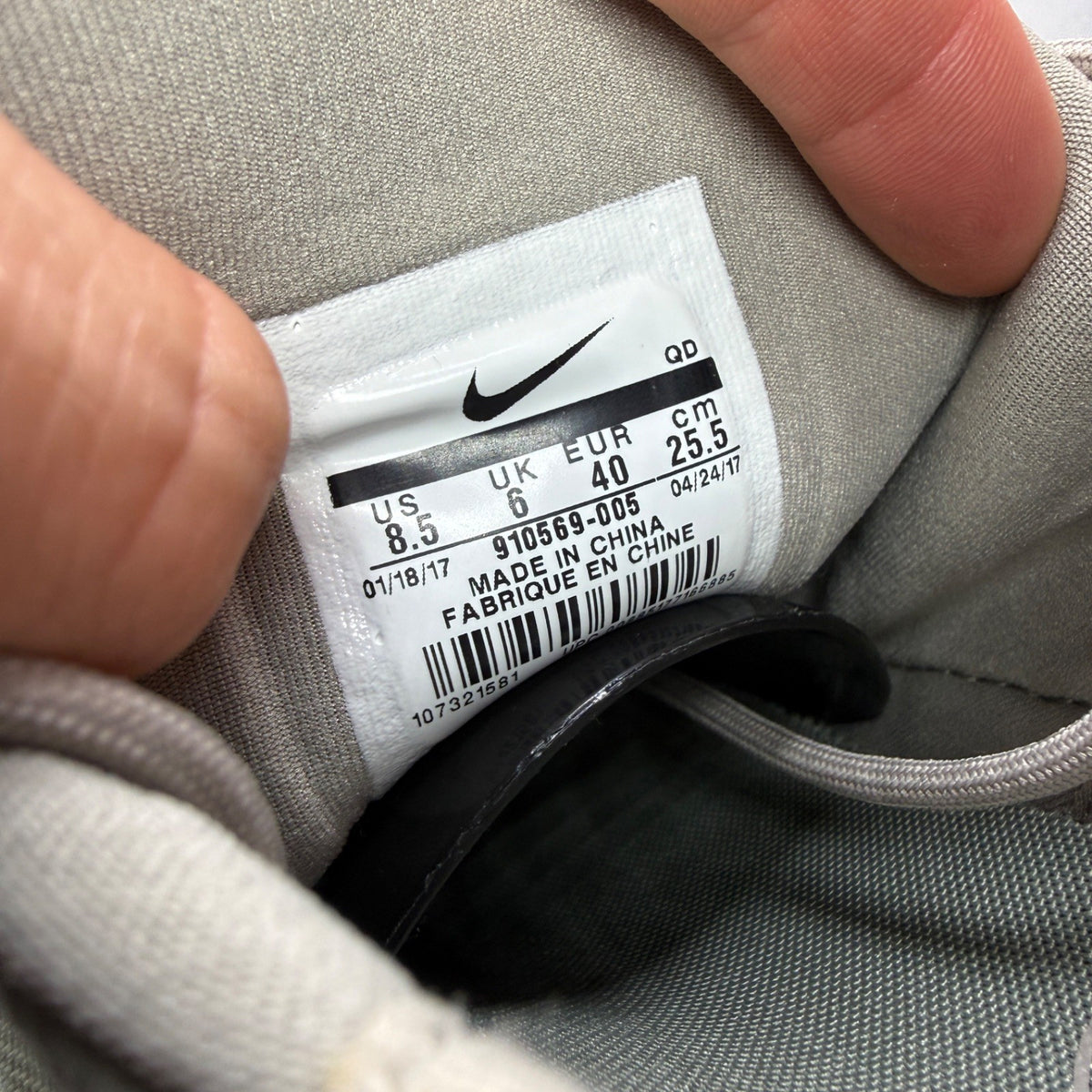 Nike trainers khaki green mesh upper with white sole and logo details.