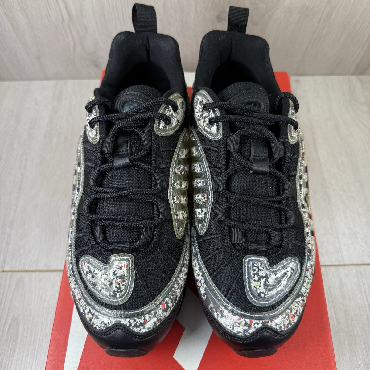 Nike Air Max 98 trainers black with white accents and signature logo detail.