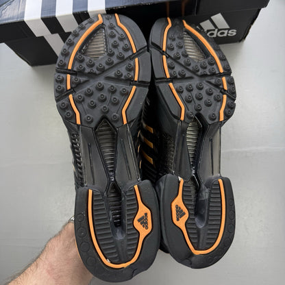 Adidas black trainers with flash orange accents and Climacool ventilation design.