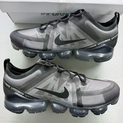 Nike Air VaporMax 2019 black trainers with distinctive air cushioning and sleek design.
