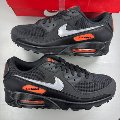 Nike Air Max 90 black sneakers with total orange accents and reflective silver details.