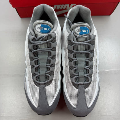 Nike Air Max 95 grey trainers with green accents and signature swoosh logo.
