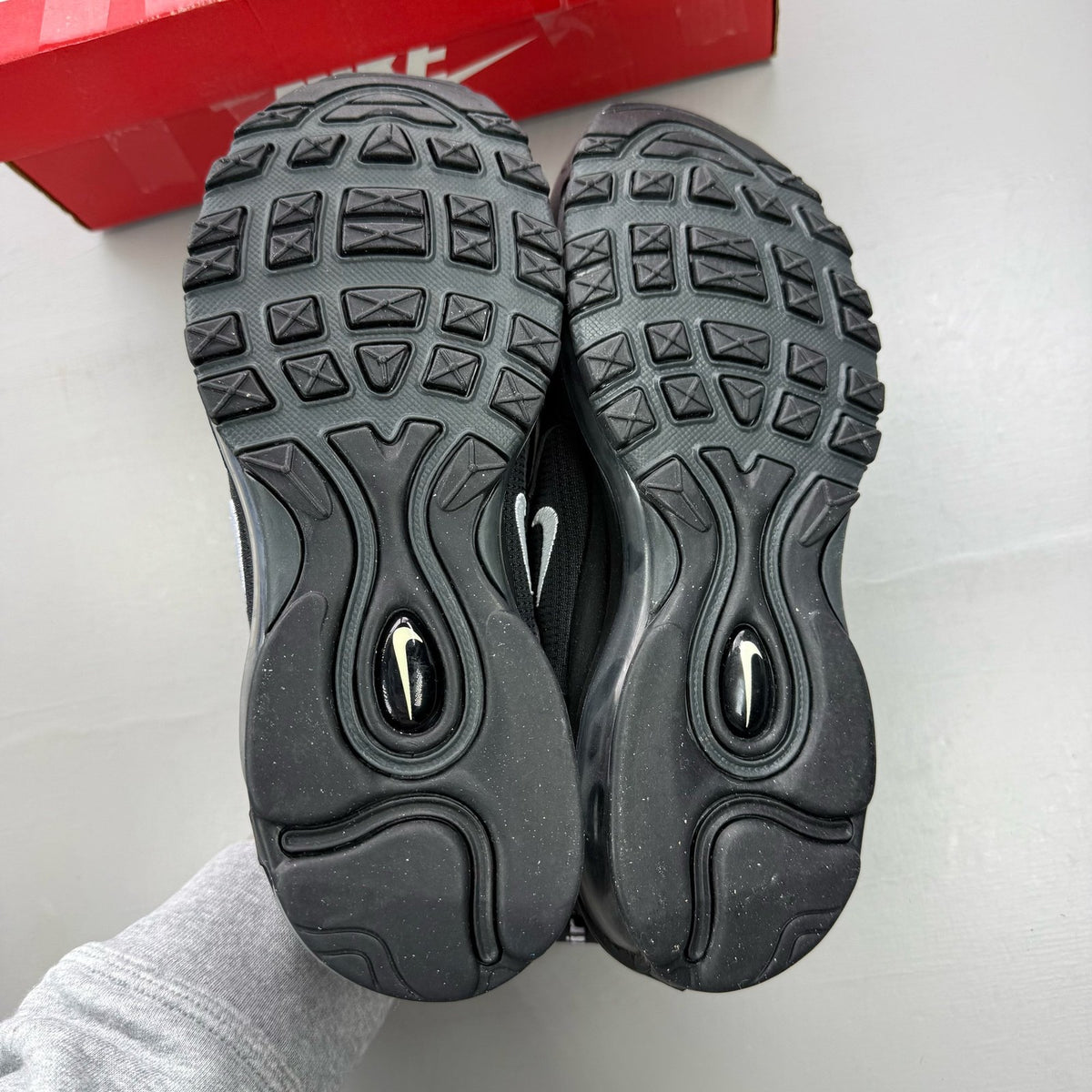 Nike Air Max 97 black trainers with anthracite accents and signature swoosh logo.