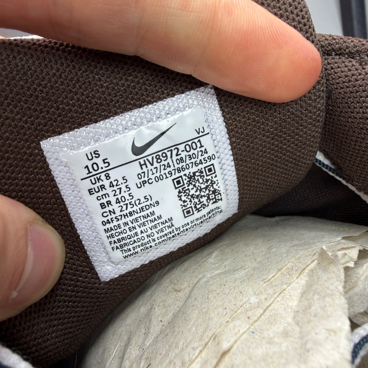 Nike deck shoes brown with white accents and logo detail.