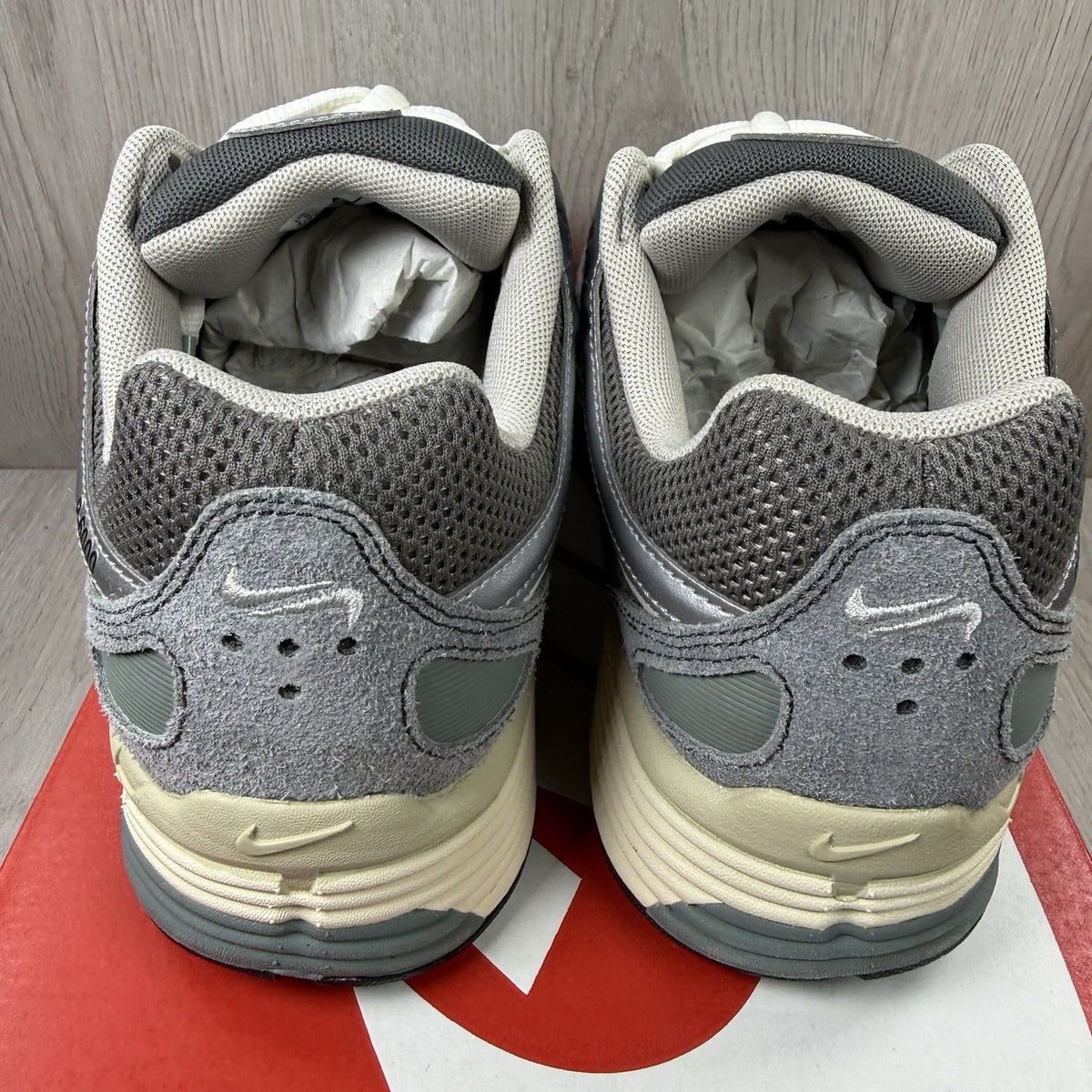 Nike grey P-6000 trainers with mesh upper and reflective detailing.