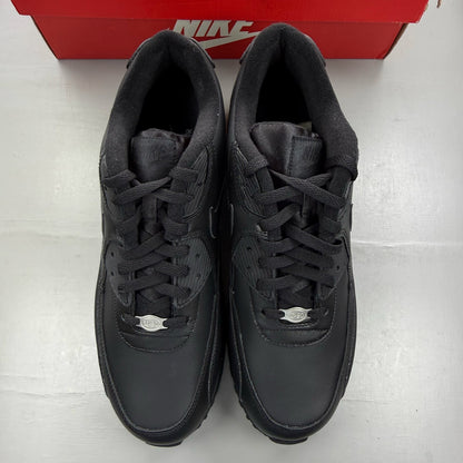 Nike black trainers leather upper with Air Max cushioning and logo detail.