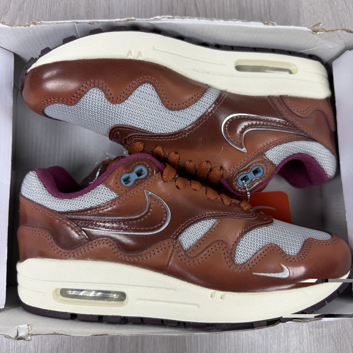 Nike Air Max 1 brown trainers with unique Patta logo and premium suede material.