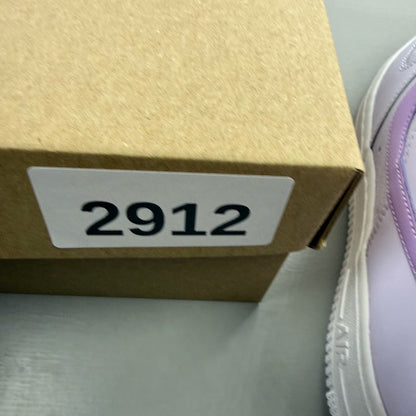 Nike Air Force 1 '07 purple trainers with classic white sole and logo detail.