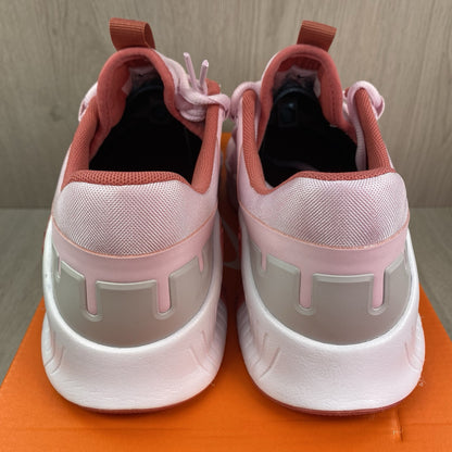 Nike Free Metcon 5 pink foam trainers with white accents and logo detailing.