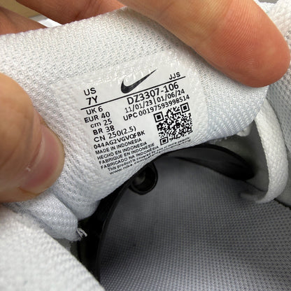 Nike Air Max 1 white trainers with black and grey accents, featuring logo details.