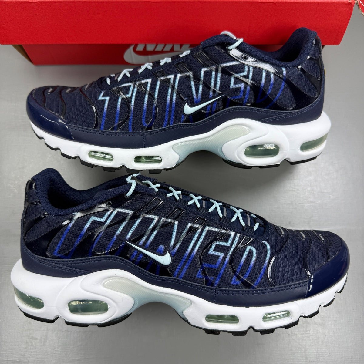 Nike blue deck shoes with logo detail and sleek design.