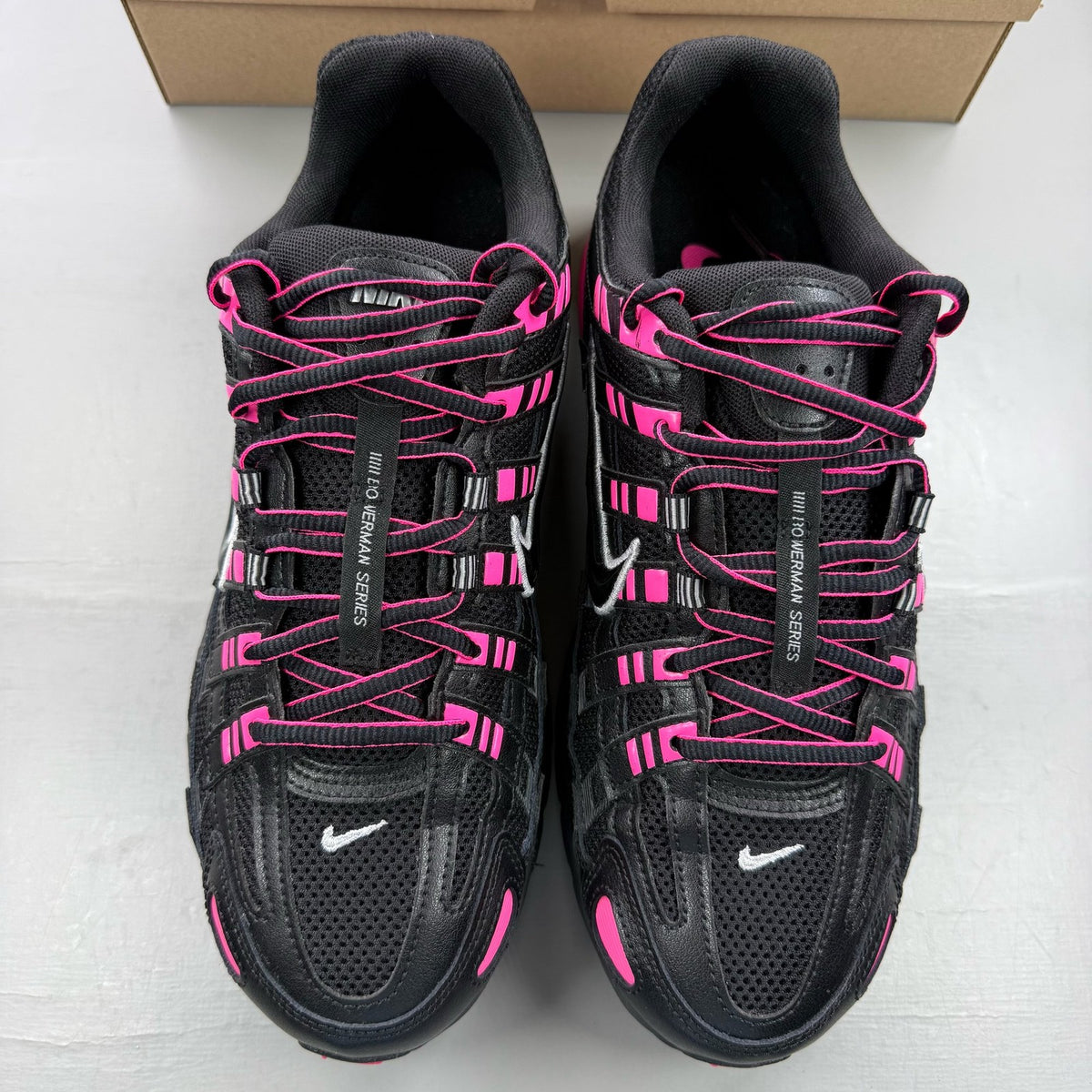 Nike P-6000 trainers black pink metallic detailing and logo accents.