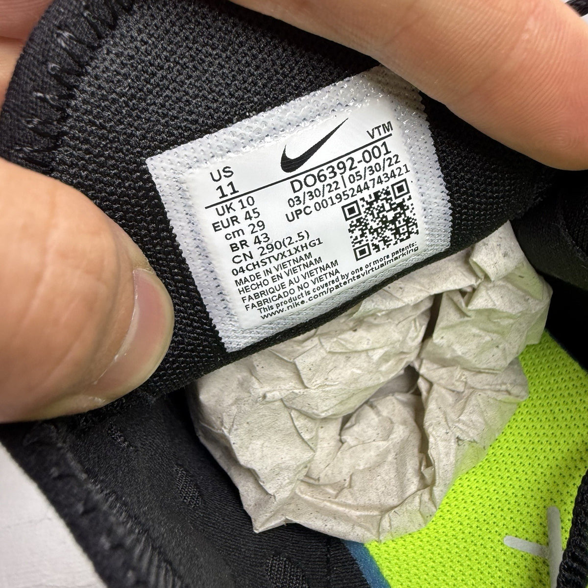 Nike Air Max 270 black trainers with neon volt accents and white sole.