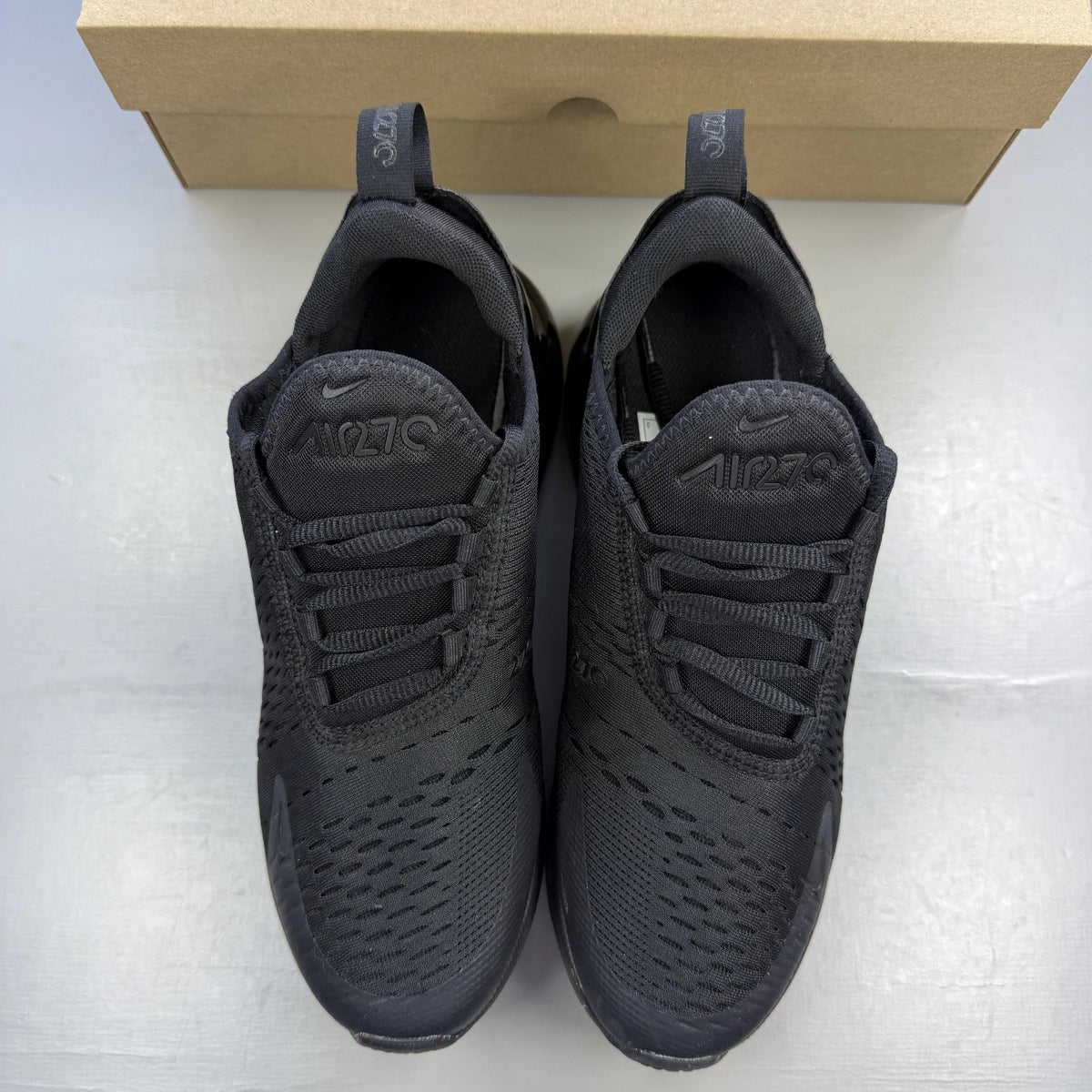 Nike Air Max 270 black trainers with logo detailing and breathable mesh upper.