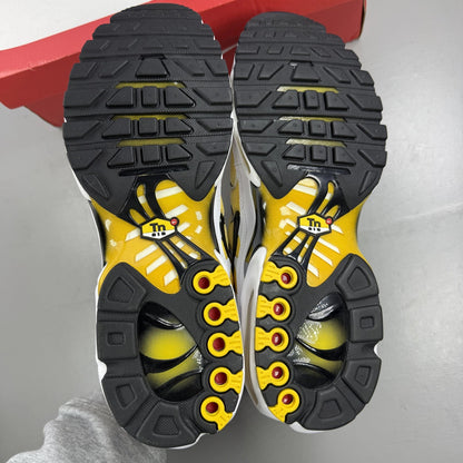 Nike Air Max Plus TN white with varsity maize yellow accents and signature logo.