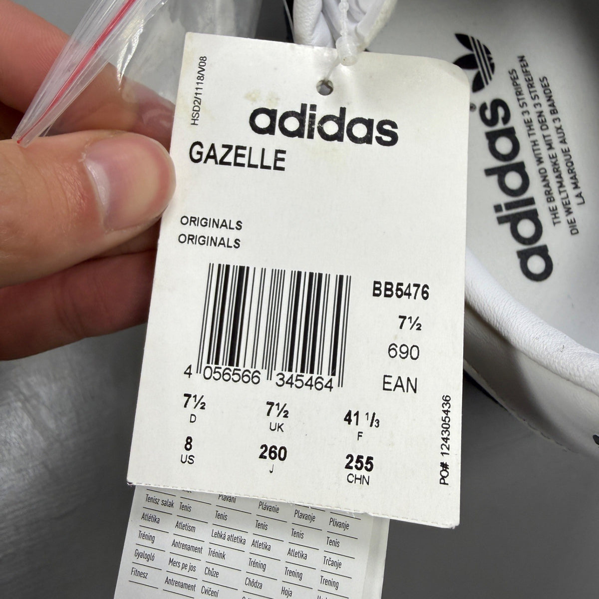Adidas black athletic shoes with white stripes and logo, size UK 7.5.