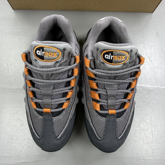 Nike Air Max 95 grey trainers with hot curry and orange accents, mesh and leather material.
