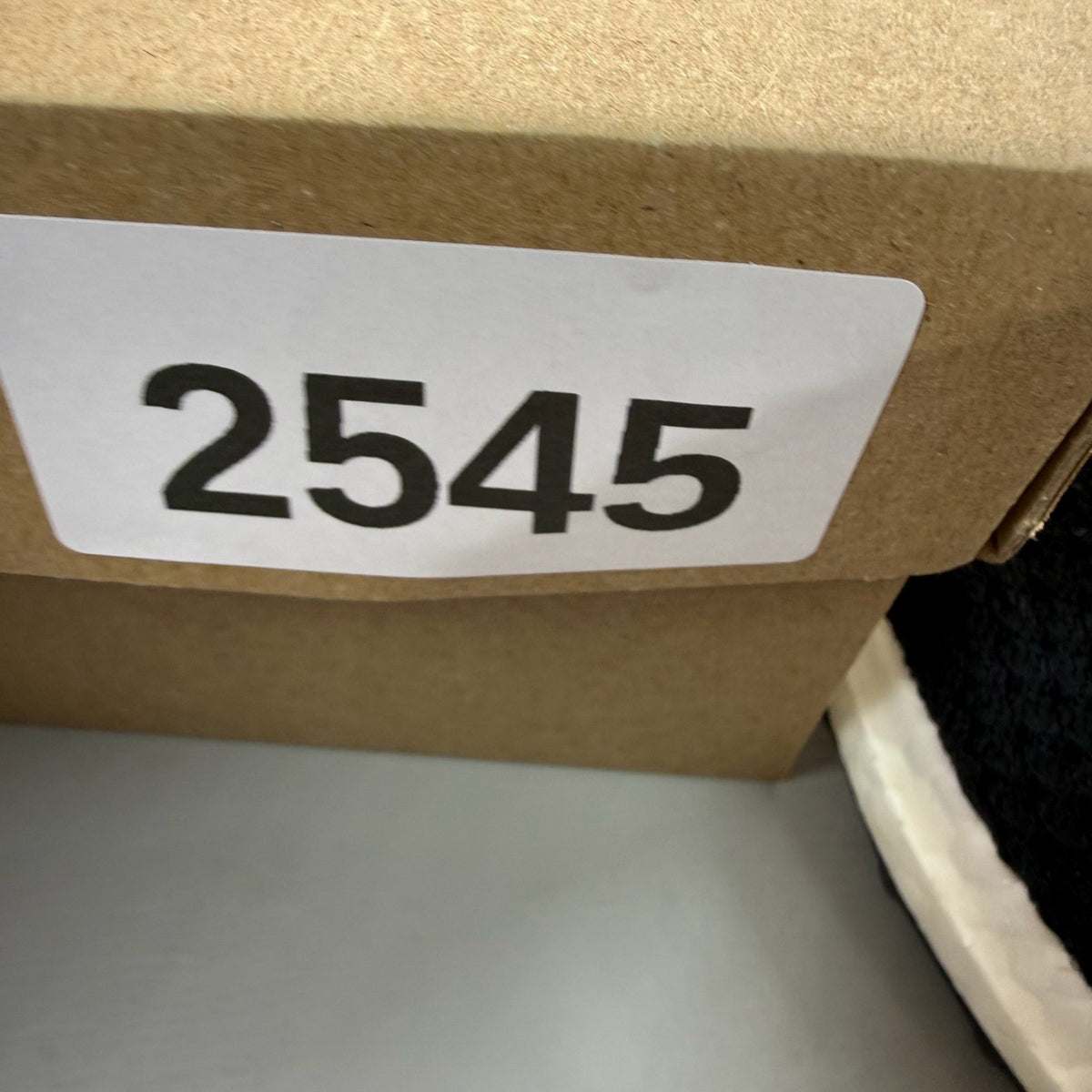 Adidas black Ultra Boost 5.0 trainers with white accents and logo detailing.