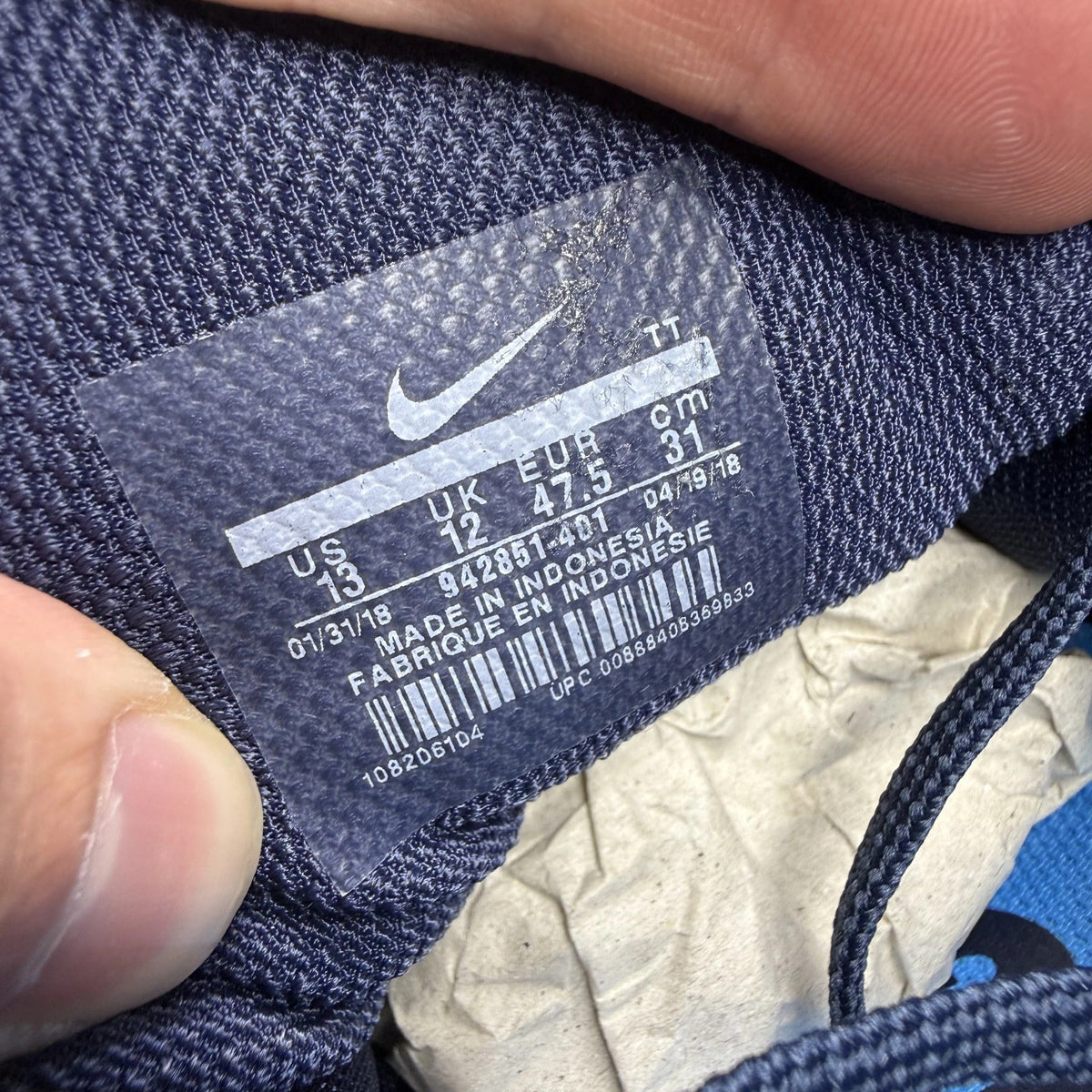 Nike blue trainers with Air Zoom cushioning and logo detailing on the side.
