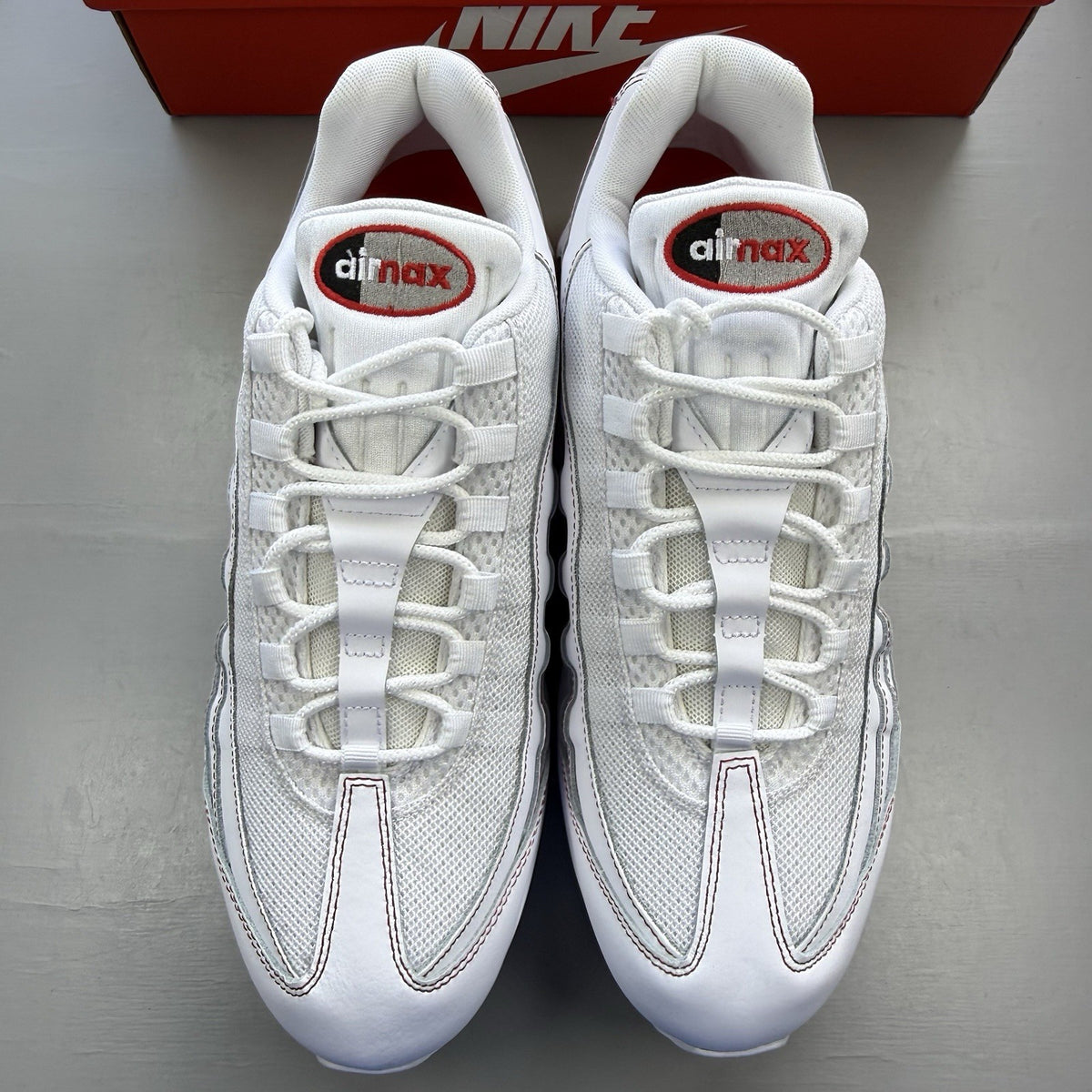 Nike Air Max 95 trainers white with university red accents and signature big bubble sole.