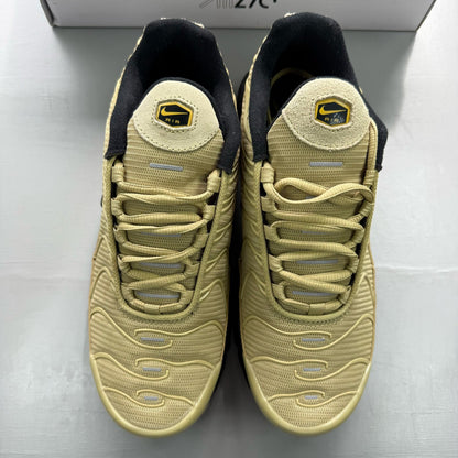 Nike Air Max Plus TN beige trainers with iconic logo and textured upper design.