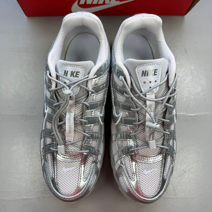 Nike deck shoes silver with logo details and sleek design.