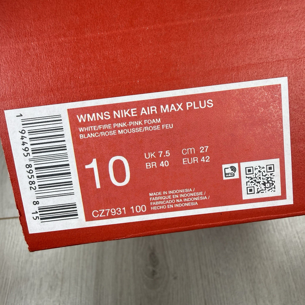 Nike Air Max Plus TN white trainers with fire pink foam fade and logo detailing.