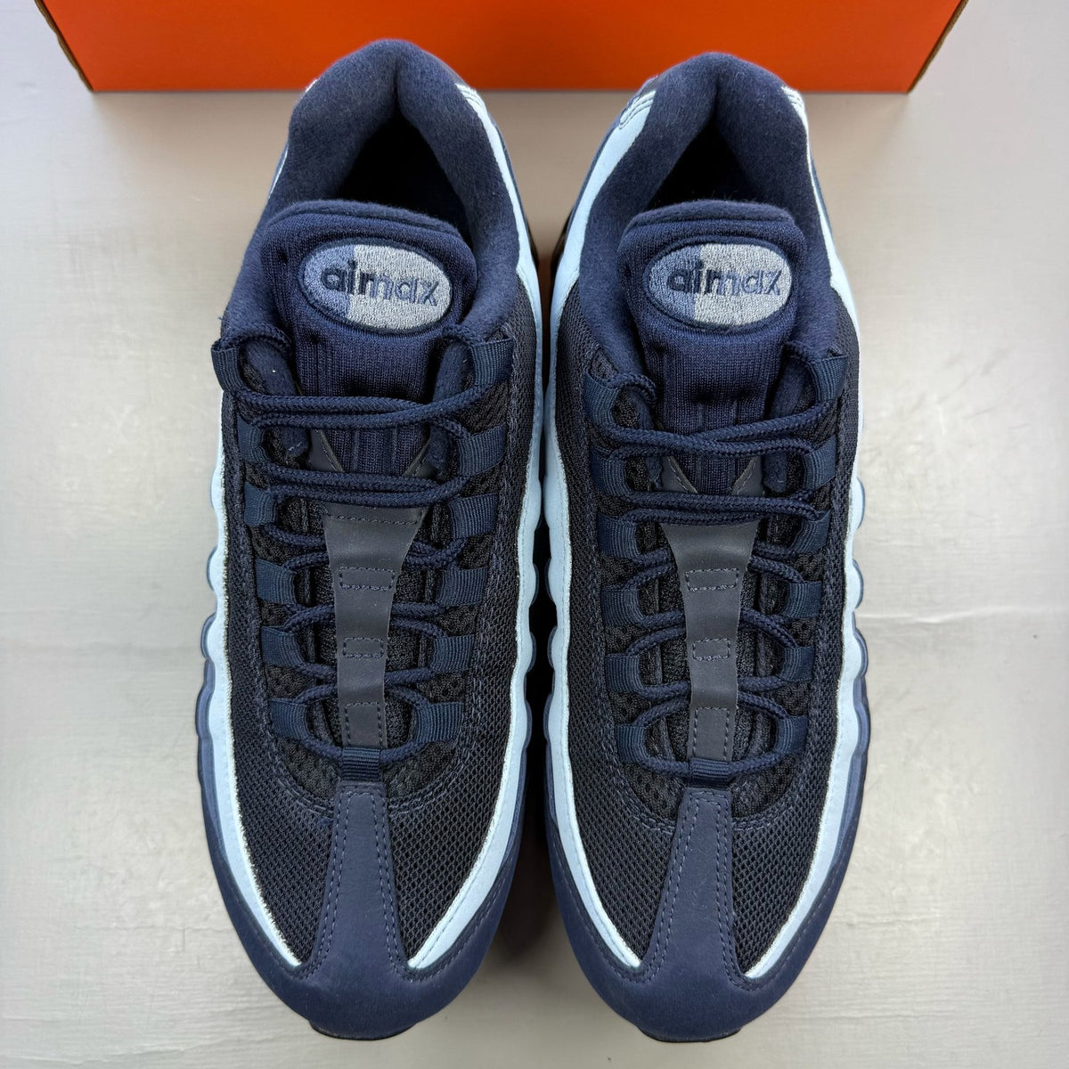 Nike Air Max 95 blue trainers with big bubble sole and logo detailing.