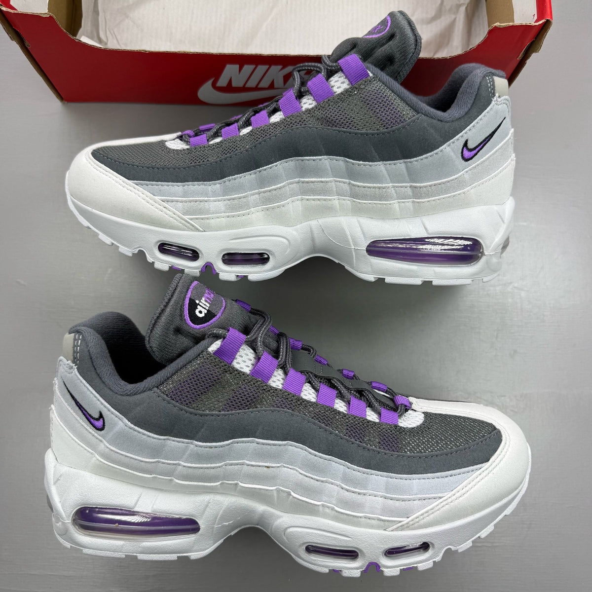Nike Air Max 95 grey trainers with big bubble sole and logo detailing.